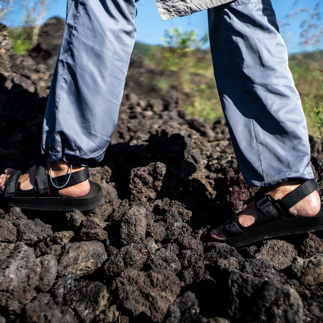man hiking in black sandals