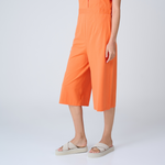 Standing woman wearing cross platform sandals in Sea Salt Sole/Sea Salt color