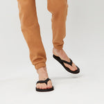 A man wearing Men’s Flip Flops - Black