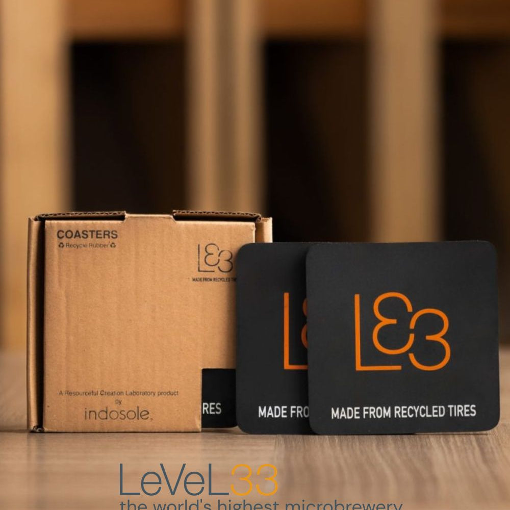 Custom Indosole recycled tire coasters branded for LeVeL33 Singapore, made from discarded tire rubber