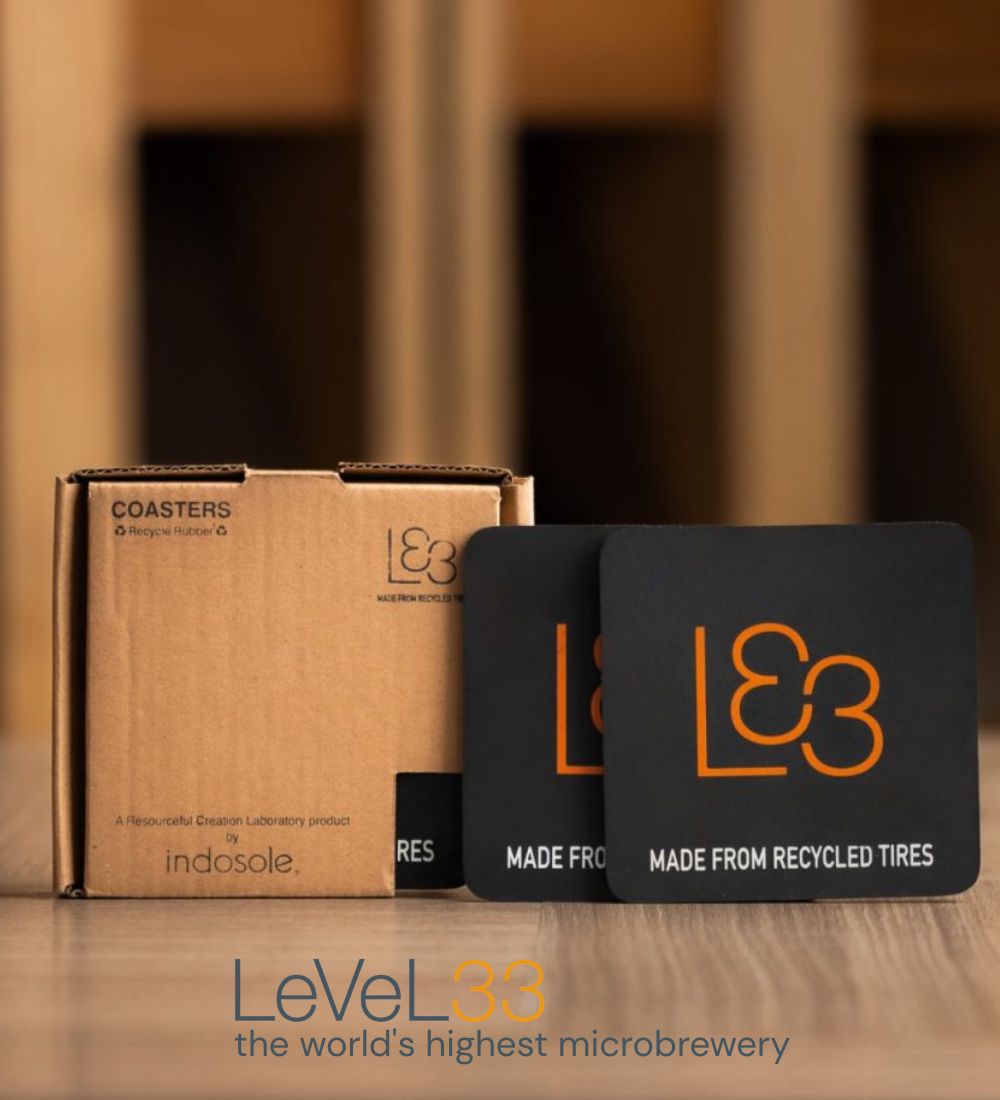 Custom Indosole recycled tire coasters branded for LeVeL33 Singapore, made from discarded tire rubber