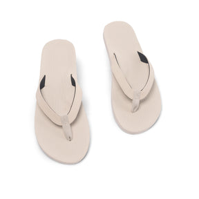 Top down angle of pair of Men's White Flip Flops - waterproof top and non-slip white recycled sneaker sole