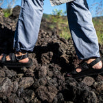 man hiking in black sandals