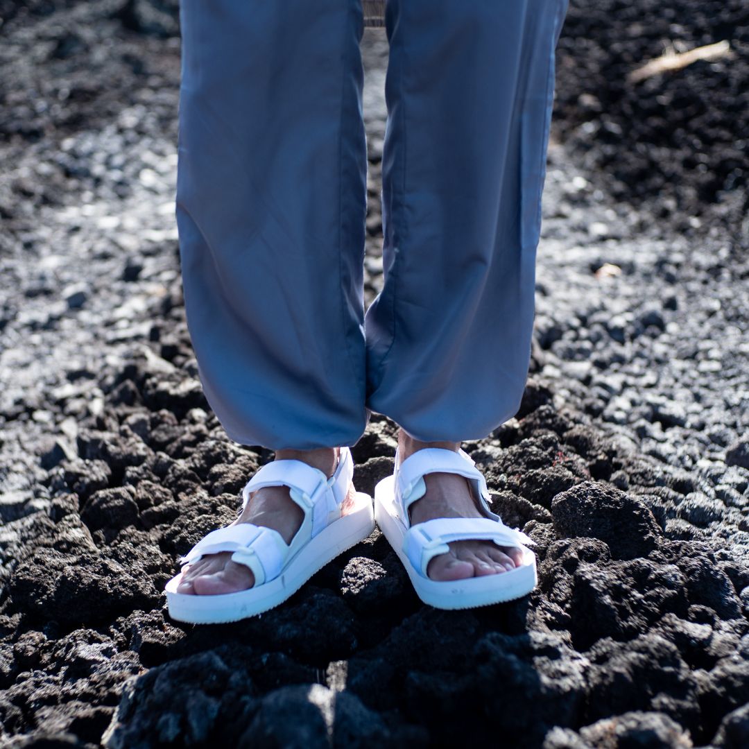 Man wearing Indosole Hi Jack Adventure Sandals in White on Gravel
