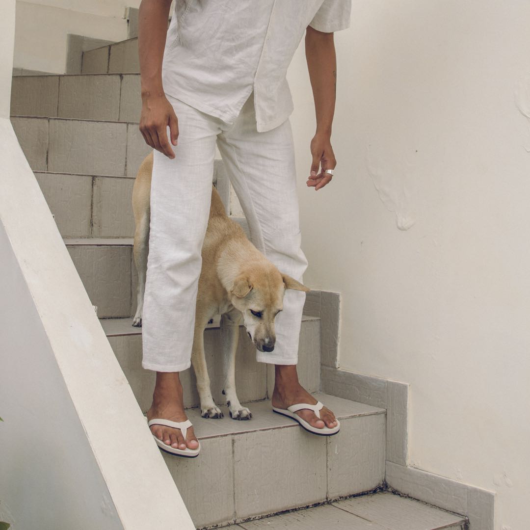 Man with a dog wearing sea salt flip flops