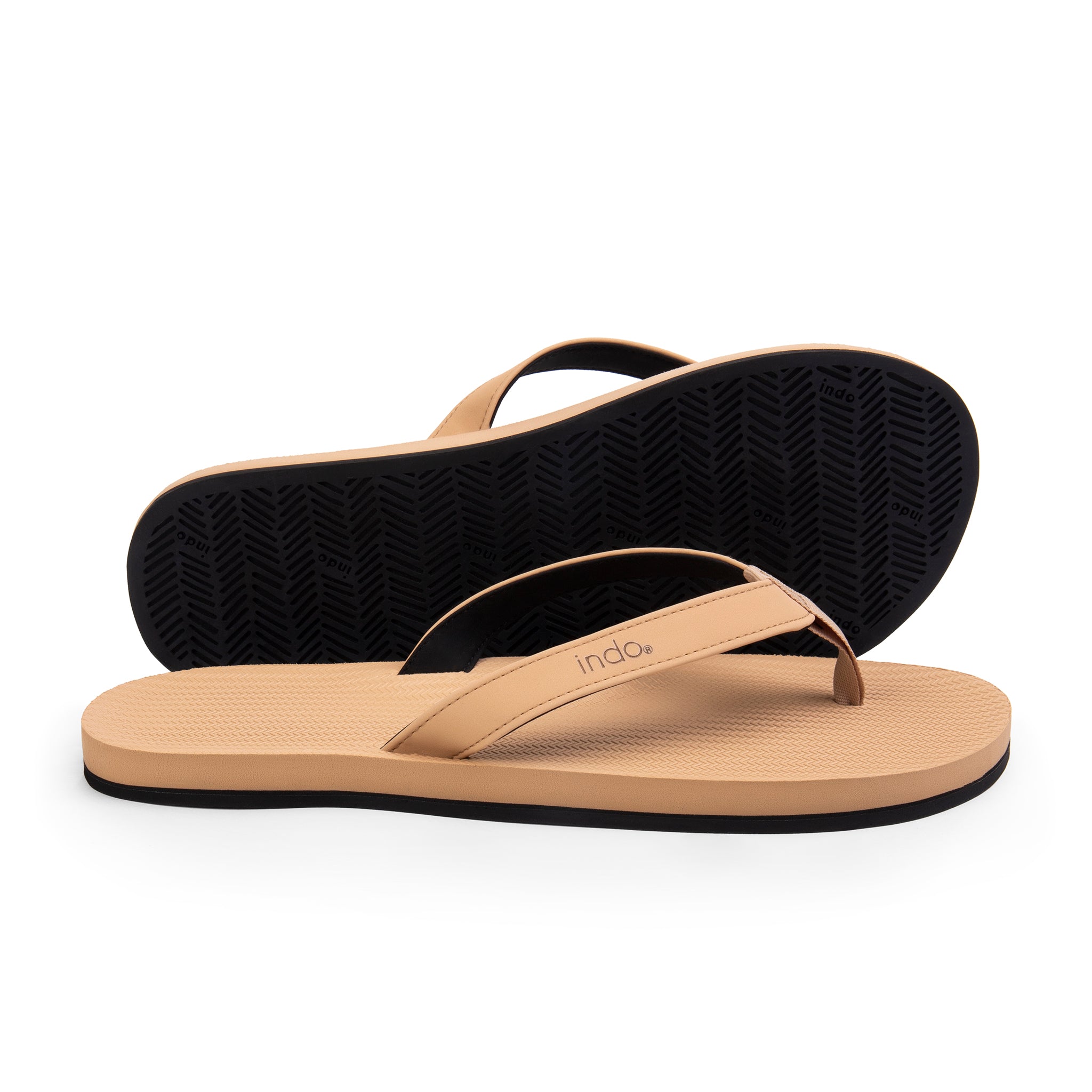 A pair of men’s flip flops in light soil color