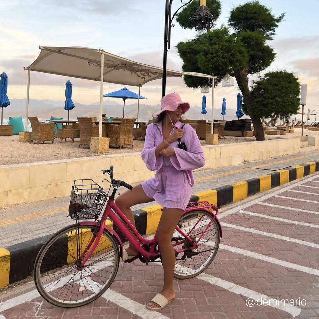 A woman on a bike wearing sea salt slides
