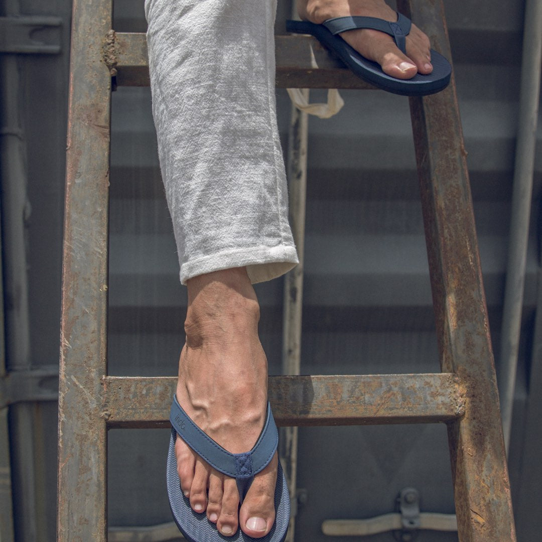 Man standing in a ladder wearing Flip Flops - Shore Color