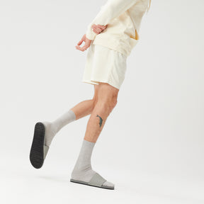 Man wearing grey pool slides with socks and shorts (2385873600589)
