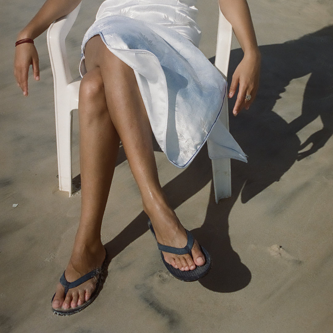 Woman on the beach wearing shore flip flops