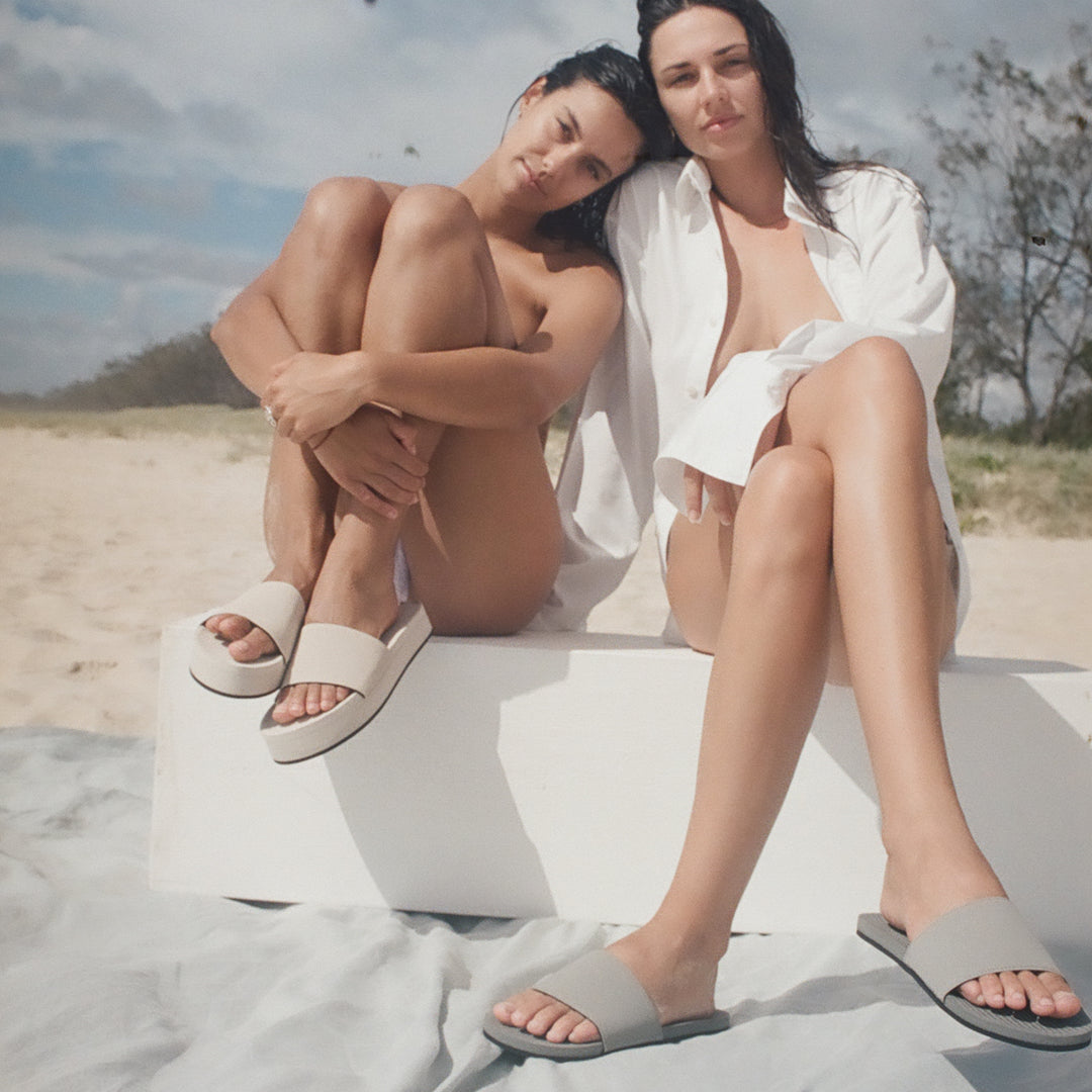 Two women wearing sea salt platform slides