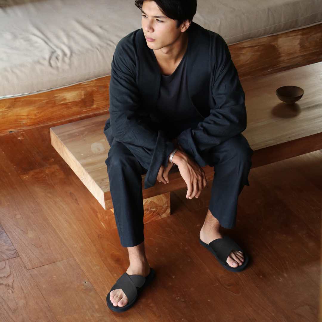 Man wearing Black Cross Sandals with Black Top and Trousers