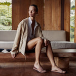 Woman wearing house slippers in light red/rust