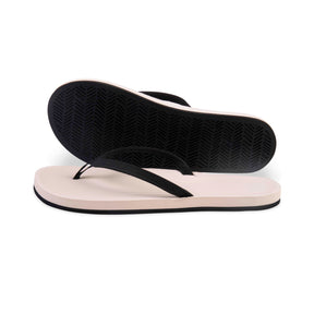 A pair of sea salt/black women's flip flops